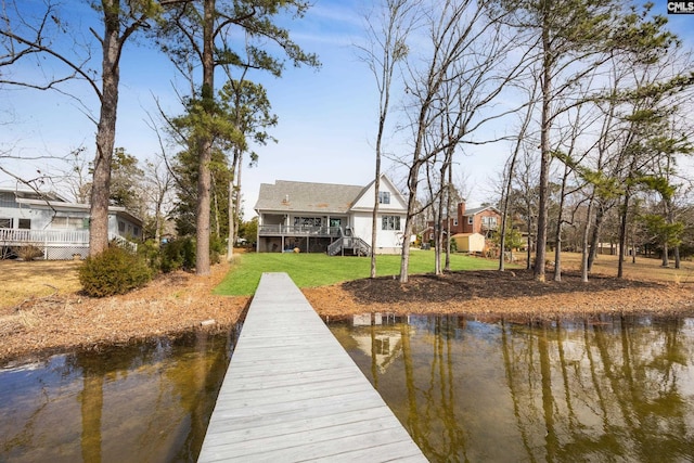 dock area with a water view, stairs, and a lawn