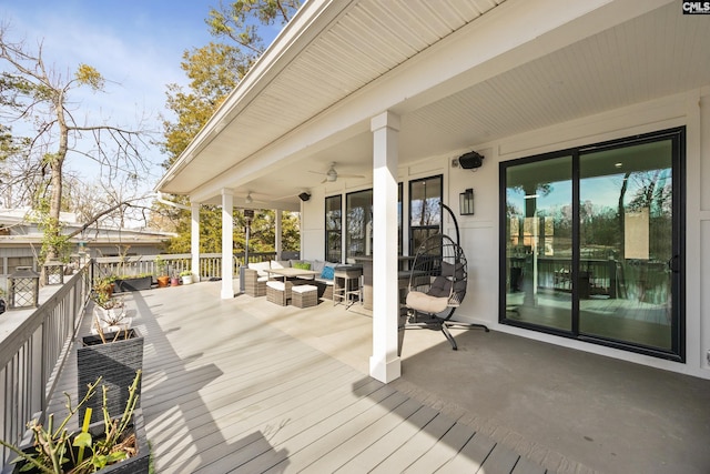 wooden terrace featuring ceiling fan and an outdoor living space