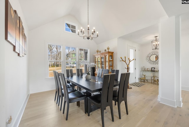 dining area featuring an inviting chandelier, light wood-style flooring, and baseboards