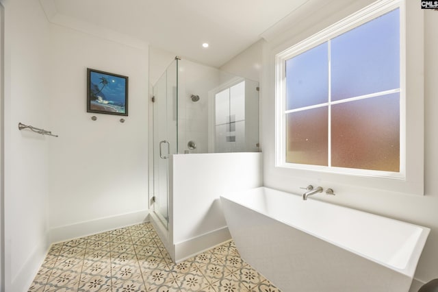 full bath with recessed lighting, a freestanding tub, a shower stall, and baseboards