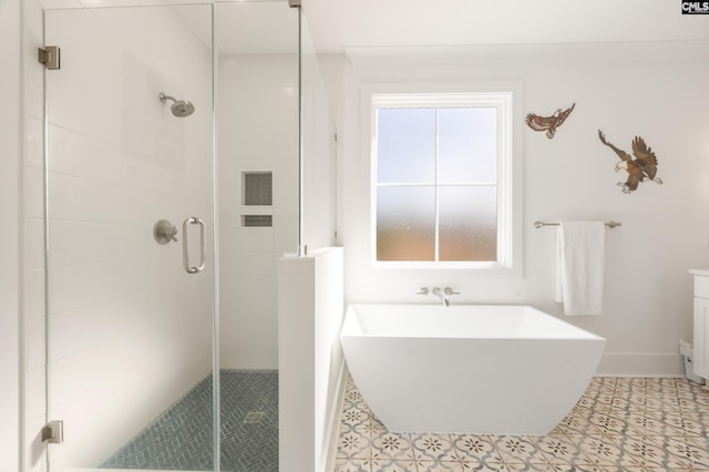 full bathroom featuring a freestanding tub and a shower stall