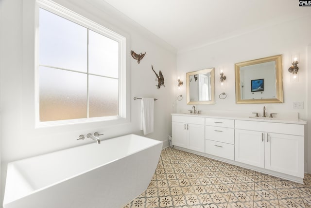 bathroom with ornamental molding, a wealth of natural light, a soaking tub, and a sink