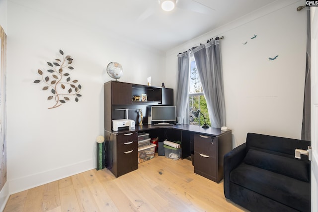 home office with baseboards, light wood-style flooring, and a ceiling fan