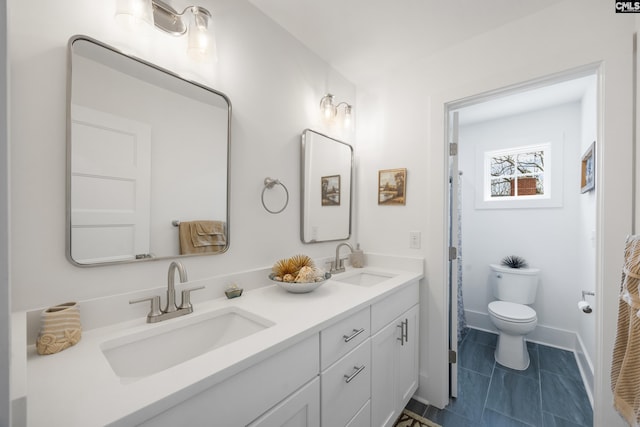 bathroom featuring tile patterned floors, a sink, toilet, and double vanity