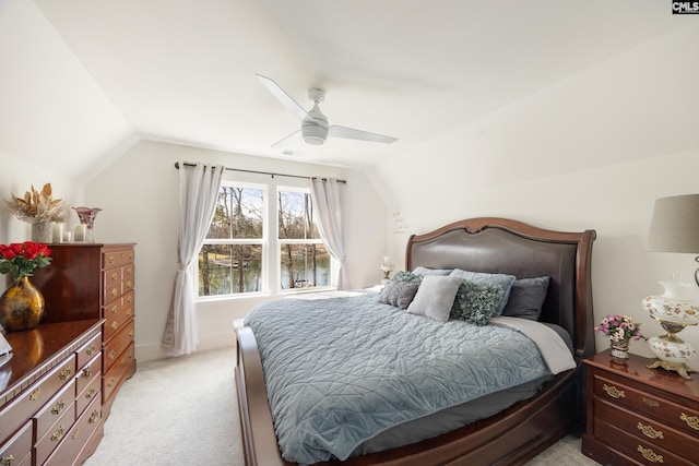 bedroom featuring lofted ceiling, ceiling fan, and light colored carpet