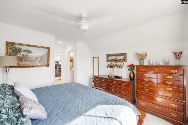 bedroom with vaulted ceiling, ceiling fan, and ensuite bath