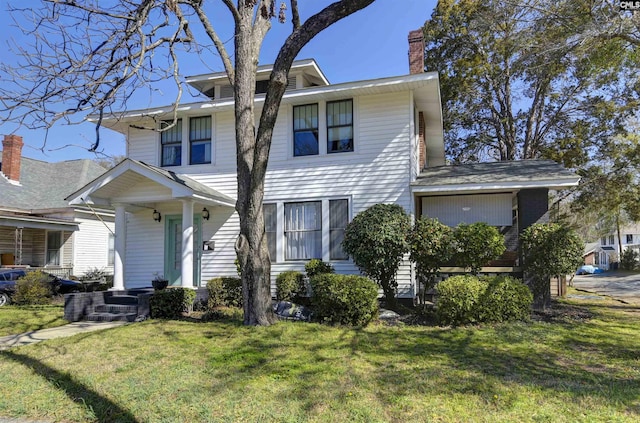 traditional style home with a chimney and a front lawn