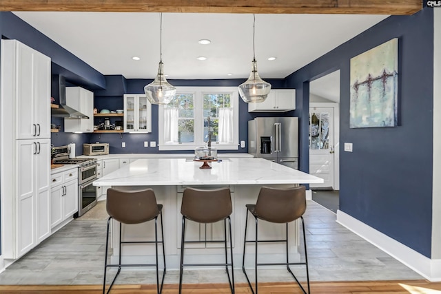 kitchen with stainless steel appliances, white cabinets, a kitchen island, and open shelves