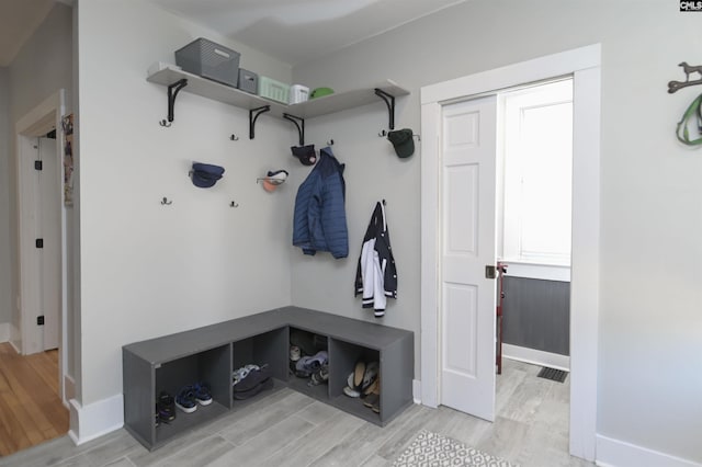 mudroom featuring baseboards and light wood-style floors