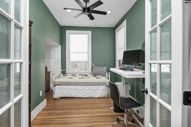 bedroom with french doors, recessed lighting, and light wood-style floors