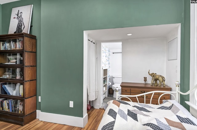 bedroom featuring baseboards and light wood finished floors