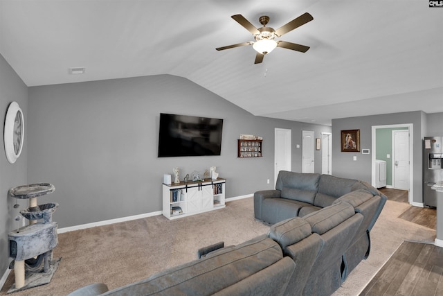 living room featuring vaulted ceiling, baseboards, and ceiling fan