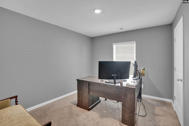 office space featuring light colored carpet, visible vents, and baseboards