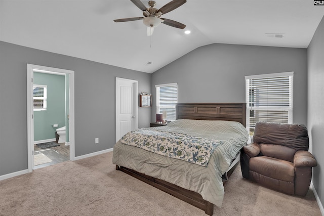 bedroom with lofted ceiling, connected bathroom, carpet floors, visible vents, and baseboards