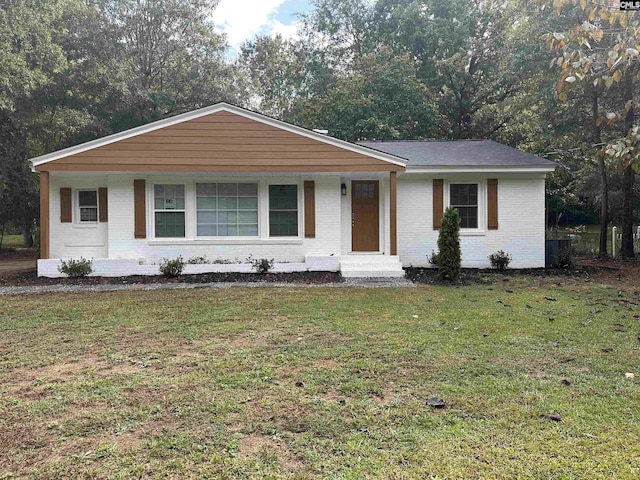 view of front of property with brick siding and a front yard