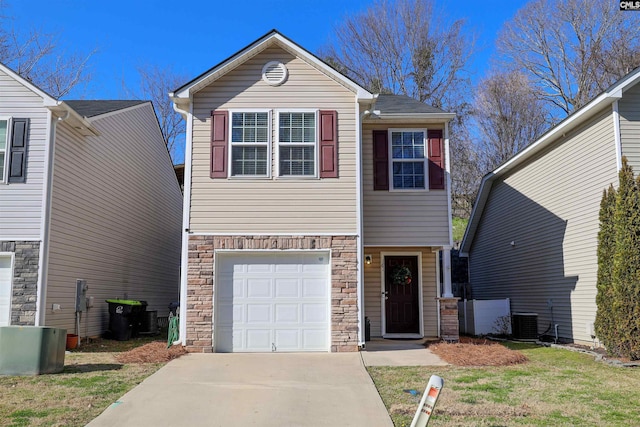 view of front of home featuring a garage, stone siding, driveway, and central AC unit