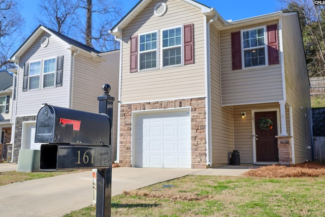 view of front of property featuring an attached garage, stone siding, and concrete driveway