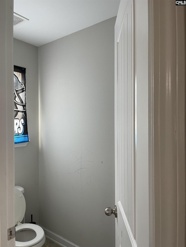 bathroom featuring visible vents and toilet