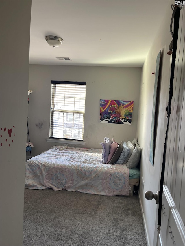 carpeted bedroom featuring visible vents and baseboards