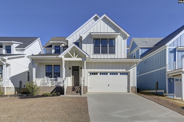 modern inspired farmhouse featuring a garage, covered porch, board and batten siding, and concrete driveway