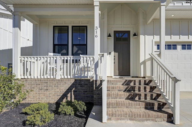 doorway to property with board and batten siding and a porch