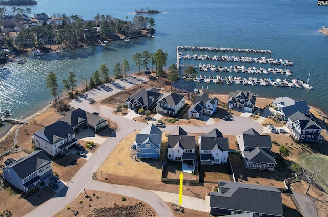 birds eye view of property with a water view and a residential view