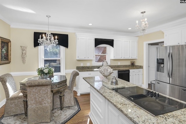 kitchen with white cabinets, black appliances, and an inviting chandelier