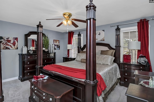 bedroom featuring multiple windows, baseboards, and carpet flooring