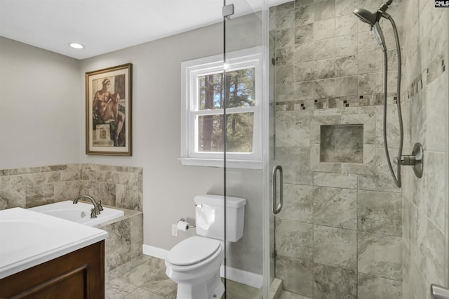 full bathroom featuring a stall shower, baseboards, toilet, a garden tub, and vanity