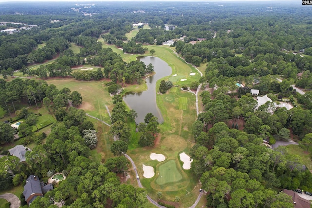 birds eye view of property with a forest view, golf course view, and a water view