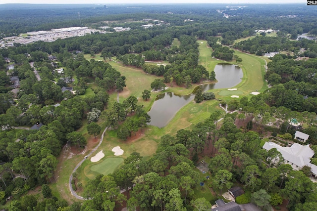 aerial view with a water view, a view of trees, and golf course view