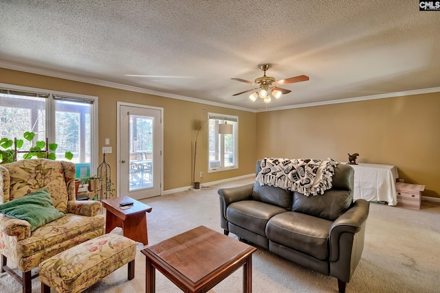 living area with a textured ceiling, baseboards, crown molding, and light colored carpet