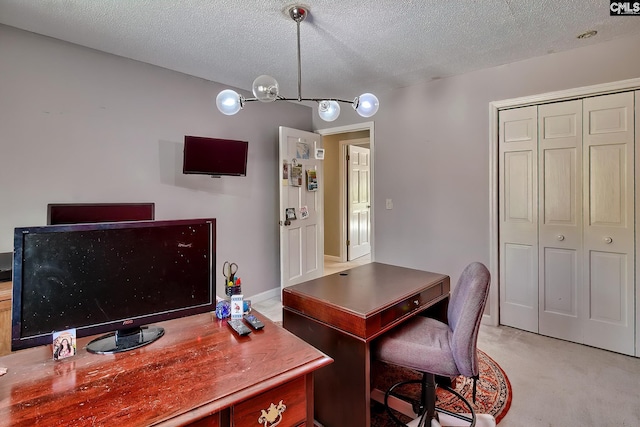 office space with a chandelier, light carpet, and a textured ceiling