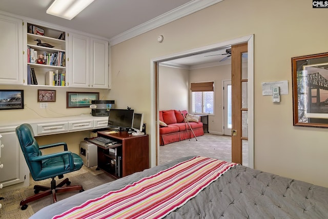 bedroom with built in desk, crown molding, and carpet flooring