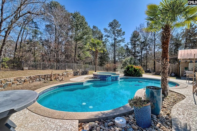 view of pool featuring a pool with connected hot tub, a fenced backyard, and a patio