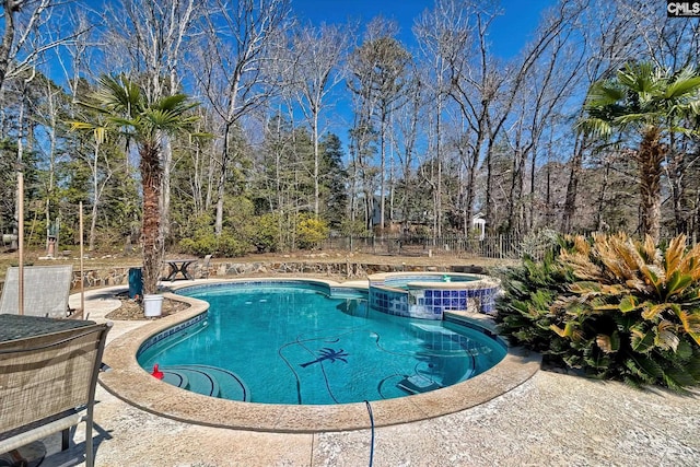 view of pool featuring a pool with connected hot tub