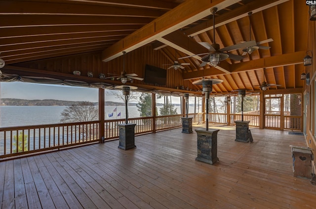 deck with a water view and a ceiling fan