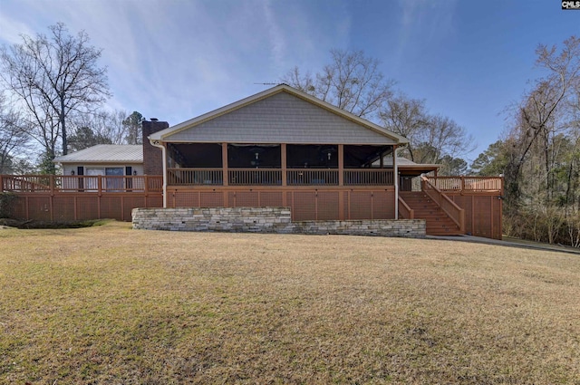 rear view of property with stairs, a yard, a chimney, and a wooden deck