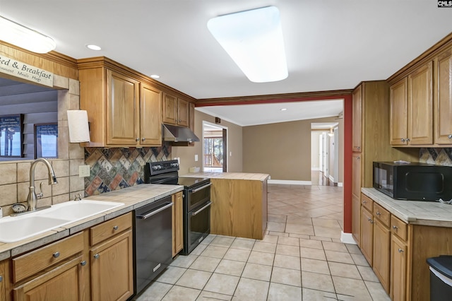 kitchen featuring light tile patterned floors, tile counters, under cabinet range hood, black appliances, and a sink