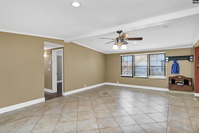 unfurnished room with ornamental molding, a ceiling fan, baseboards, and light tile patterned floors