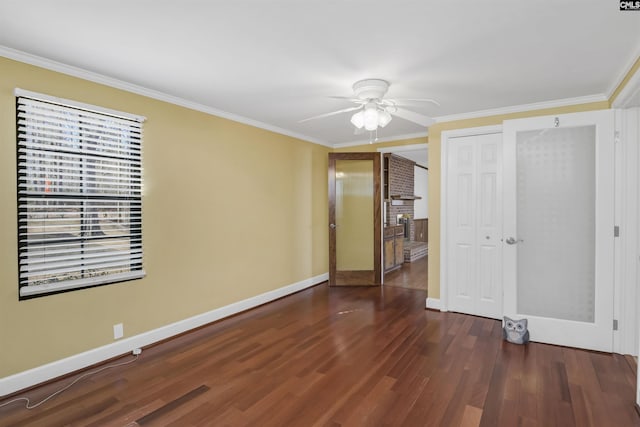 unfurnished bedroom with a ceiling fan, crown molding, baseboards, and wood finished floors