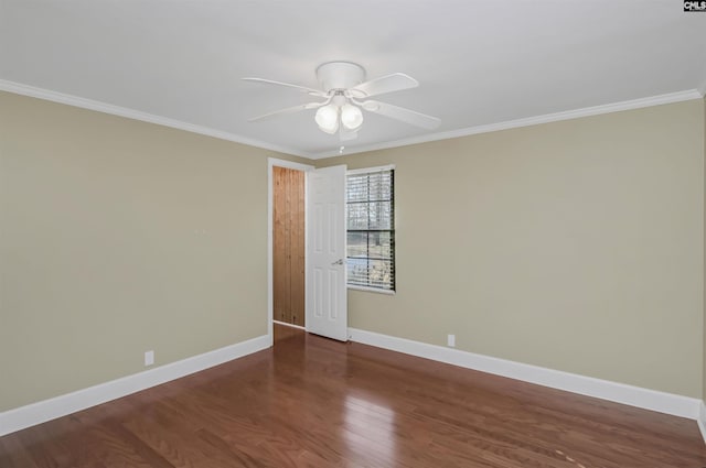 empty room featuring a ceiling fan, crown molding, baseboards, and wood finished floors