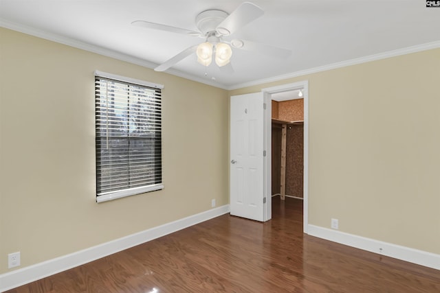 unfurnished bedroom featuring ceiling fan, baseboards, wood finished floors, and ornamental molding