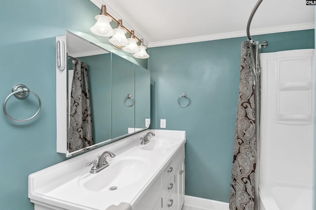 bathroom featuring double vanity, crown molding, baseboards, and a sink