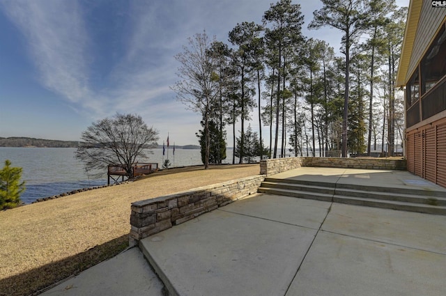 view of patio with a water view