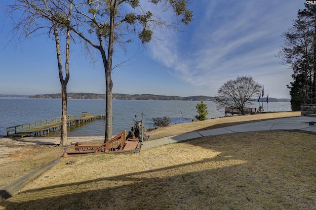 view of yard featuring a dock and a water view