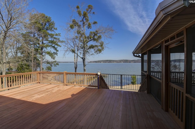 wooden terrace featuring a water view