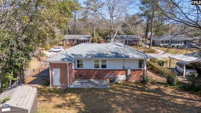 back of house featuring a patio, crawl space, fence, a yard, and brick siding