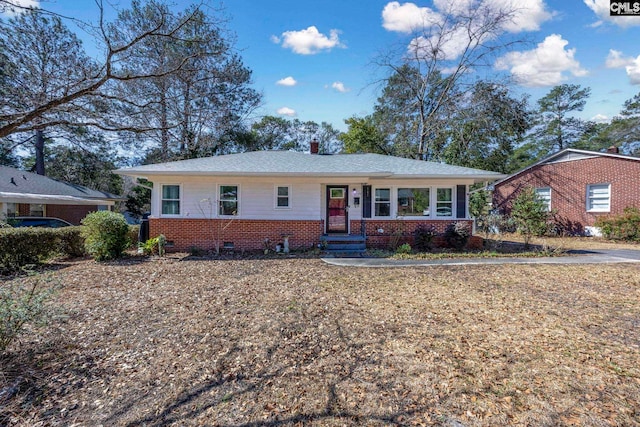 ranch-style home with crawl space, brick siding, and a chimney