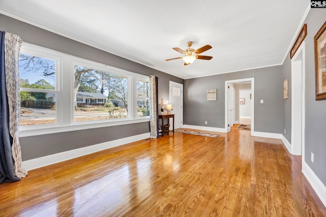 empty room featuring plenty of natural light, baseboards, and light wood-style flooring